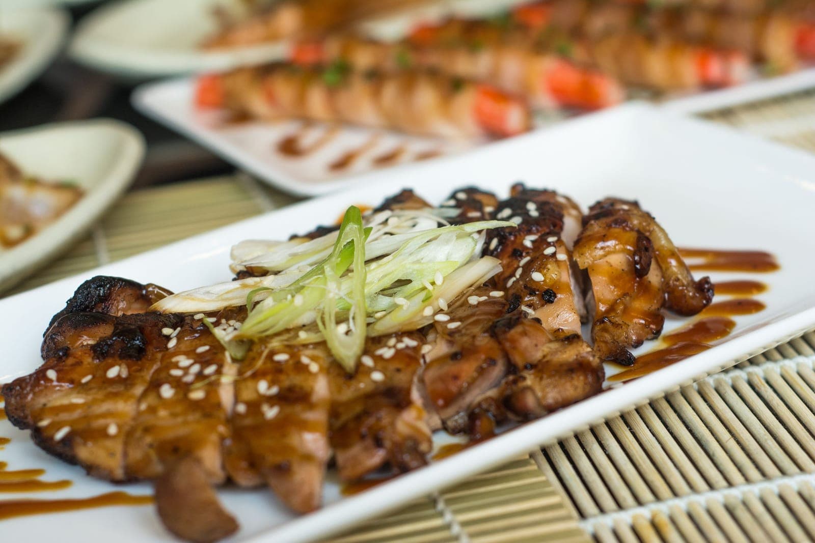 Sliced grilled chicken glazed in dark soy sauce, topped with sesame and spring onion